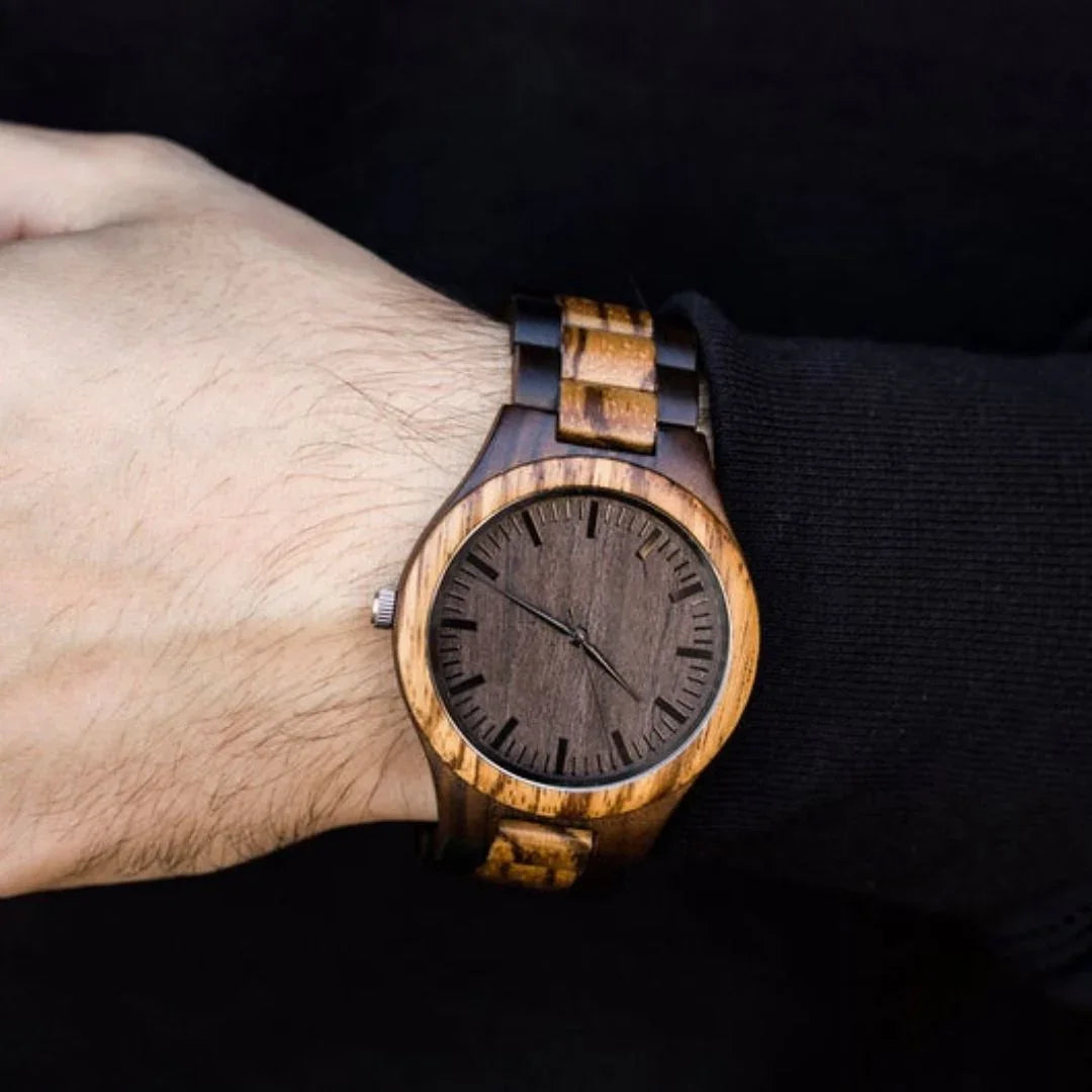 Men's wooden wristwatch with dark wood face and textured band on wrist, stylish accessory