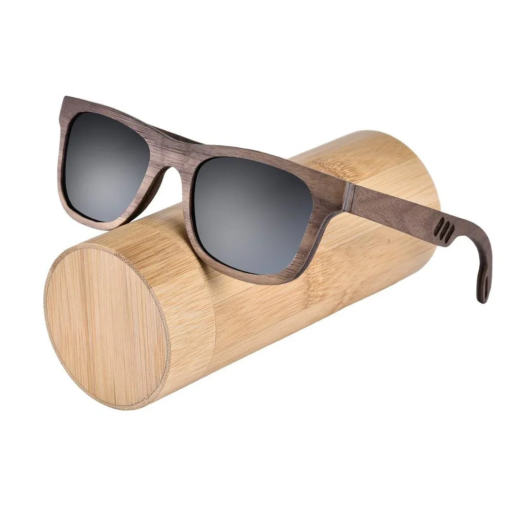 Wooden sunglasses with dark lenses on a round bamboo case, eco-friendly eyewear