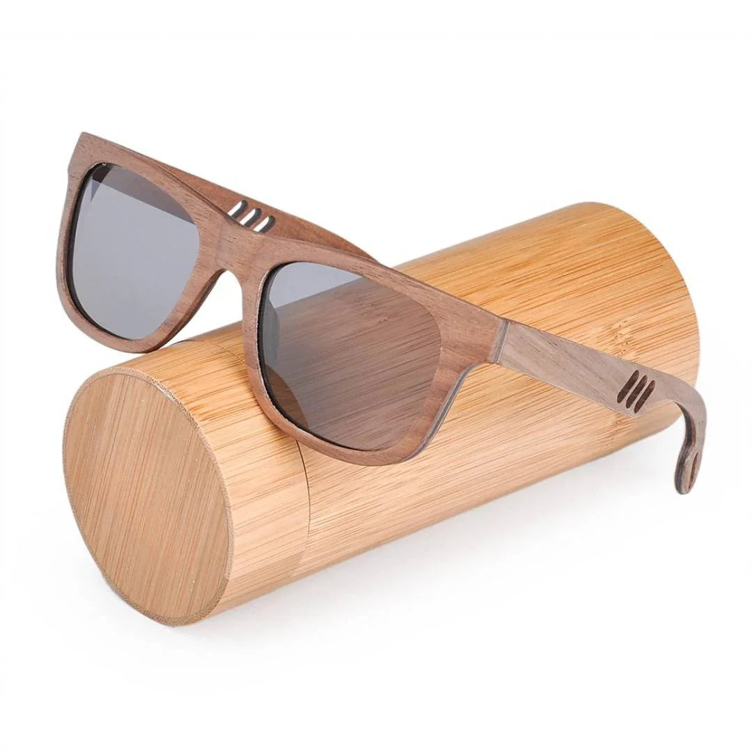 Wooden sunglasses with dark lenses on a bamboo case, eco-friendly eyewear