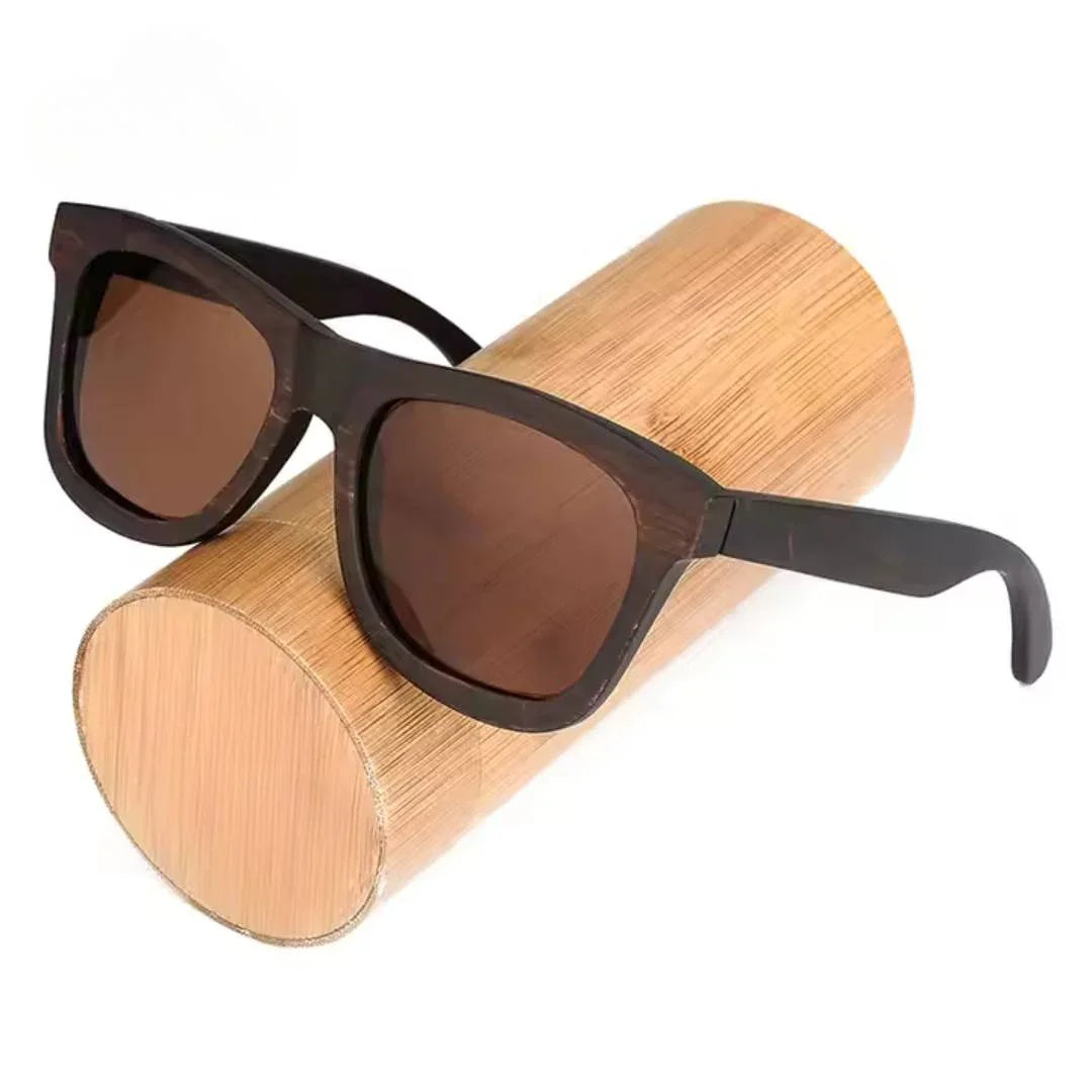 Dark wood sunglasses with brown lenses displayed on a bamboo cylinder
