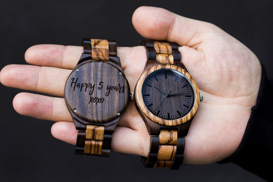 handcrafted wooden watch on moss and wood with warm sunlight and green leaves