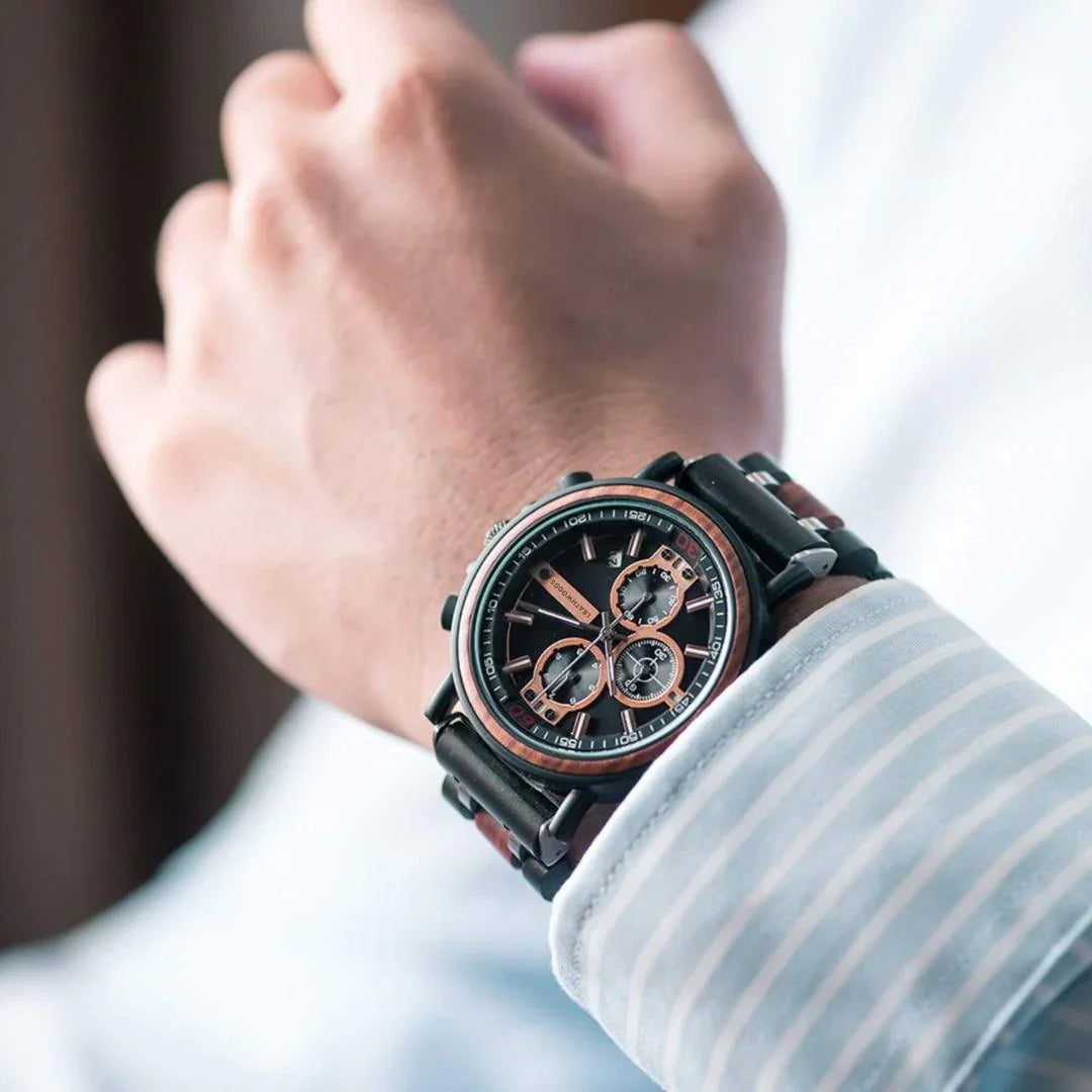 Close-up of a luxury chronograph wristwatch with black and rose gold accents on a man's wrist