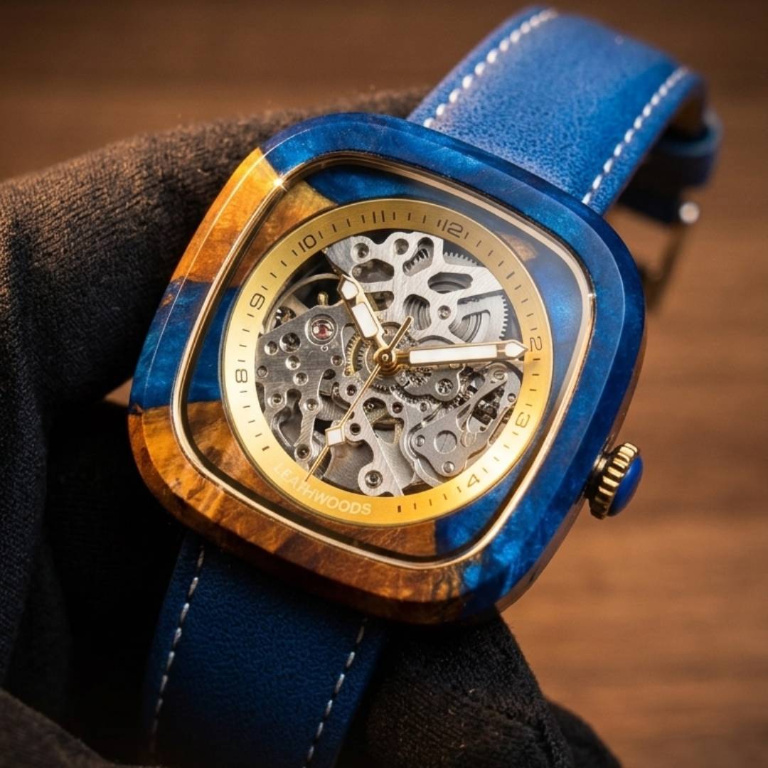 Luxury watch with blue strap and gold case on a dark background