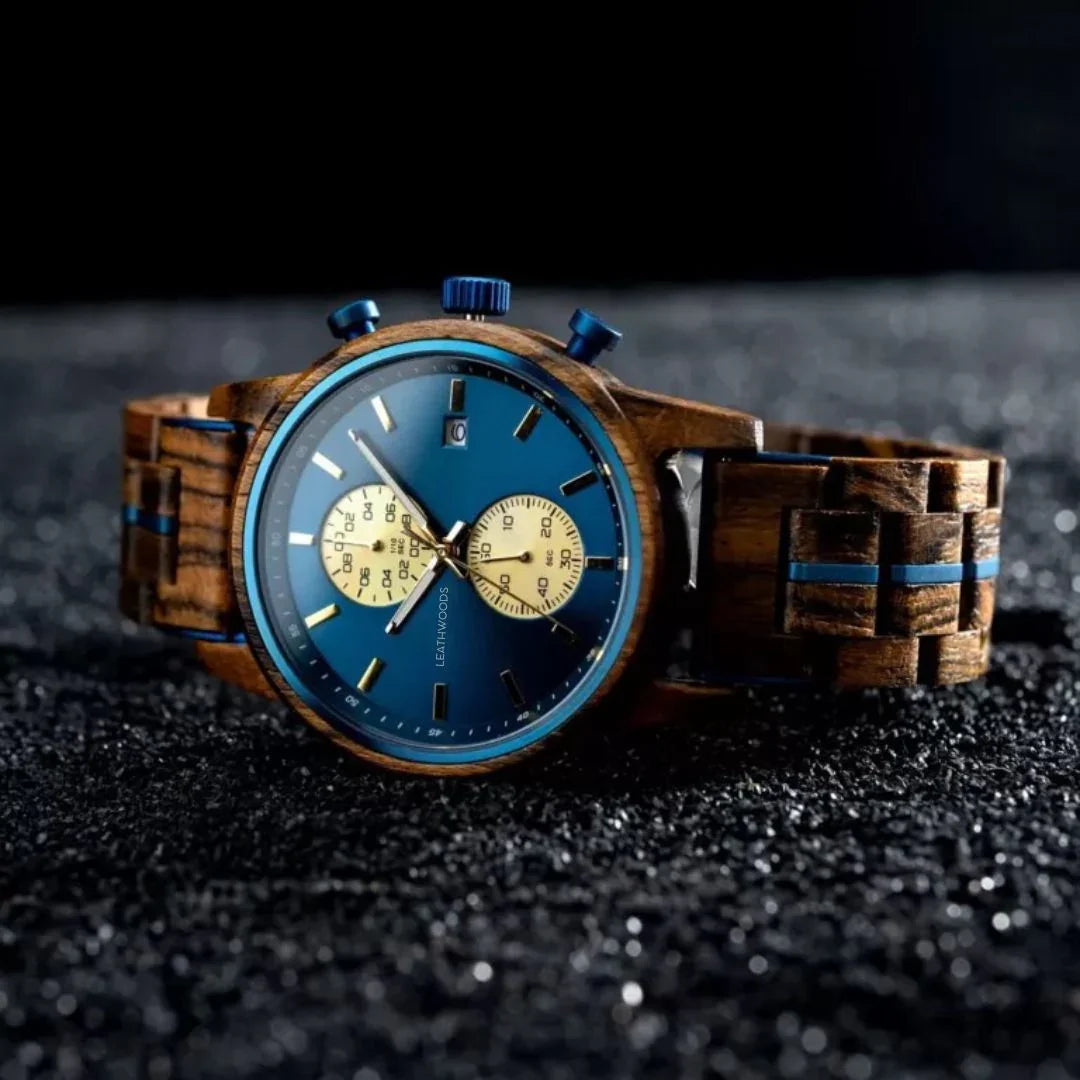 Close-up of Leathwoods wooden wristwatch with blue dial, chronograph subdials, and wooden strap on textured surface