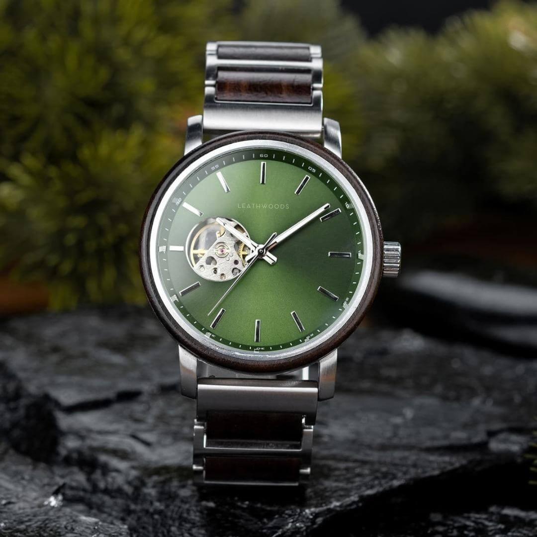 Leathwoods watch with green dial, stainless steel and wood strap, showcased on black stone surface