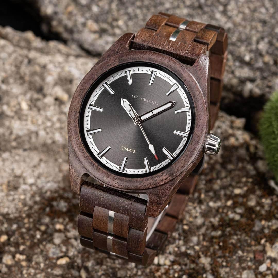 Leathwoods quartz wooden wristwatch with dark round dial and wooden strap on textured surface