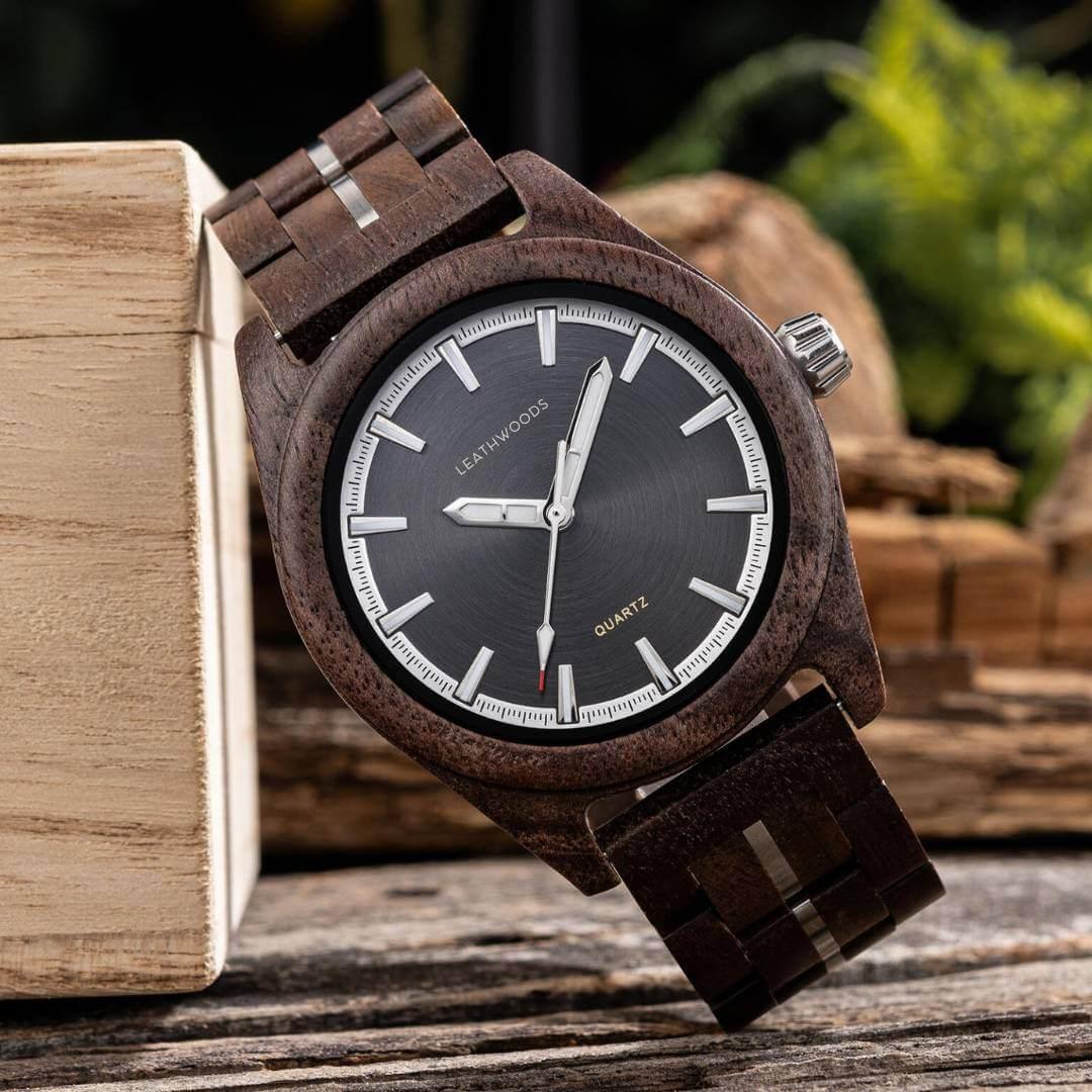 Wooden Leathwoods quartz wristwatch with dark face and silver markers on rustic wooden background