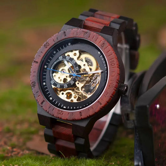 Men's wooden skeleton watch with visible gears and brown bezel on grassy surface