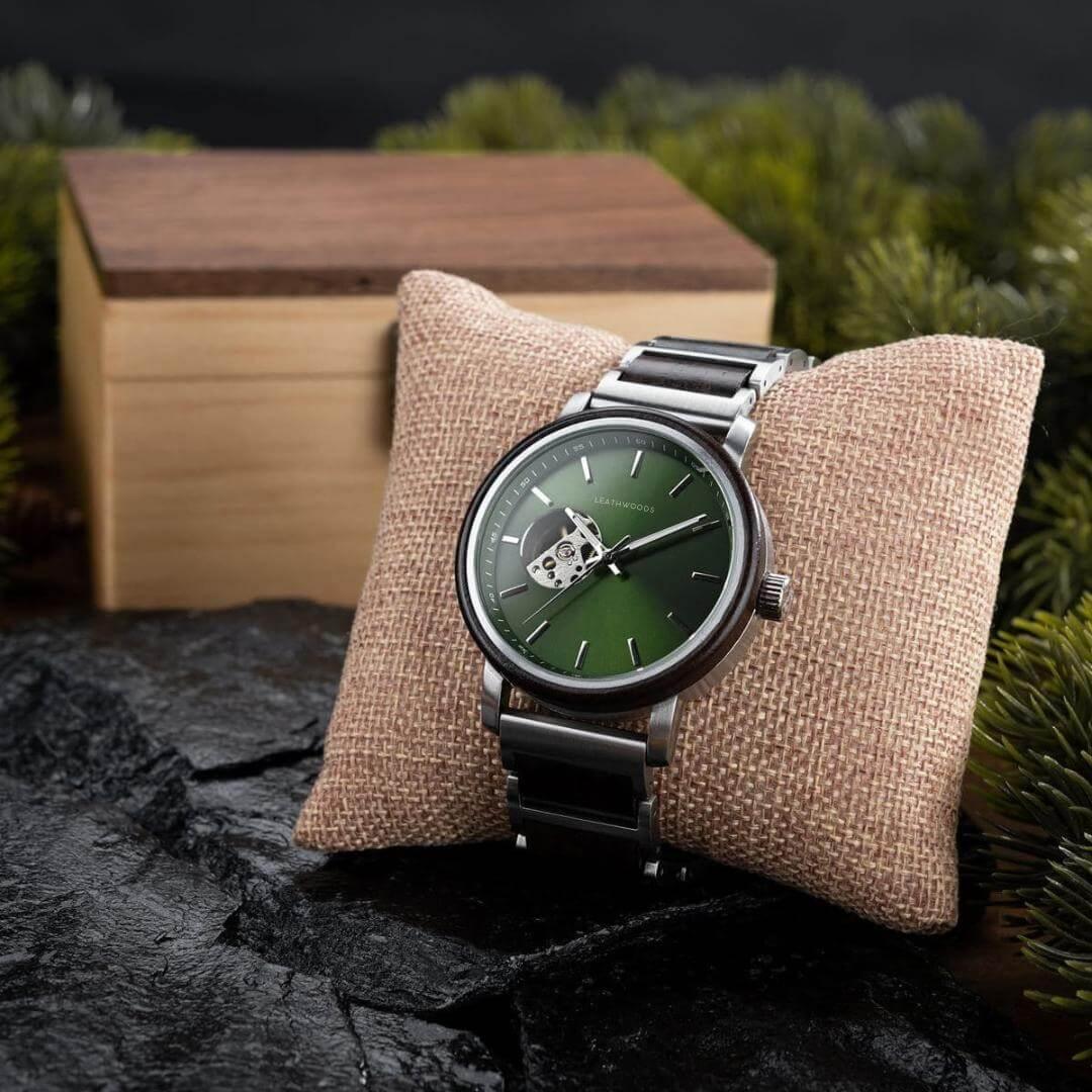 Stylish green dial Leathwoods wristwatch with metal and wood band on burlap cushion