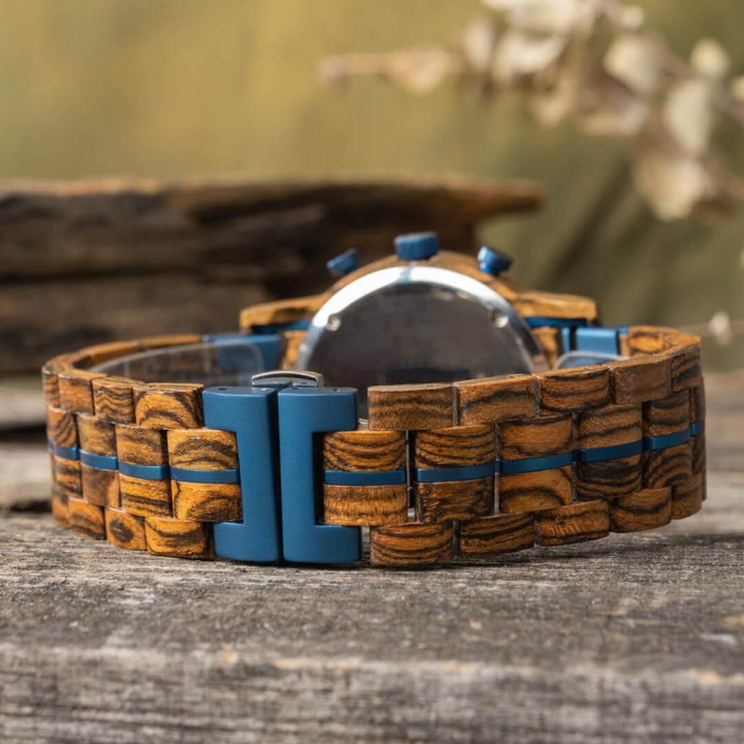 Leathwoods Morpho wooden watch with blue accents on rustic wood surface outdoors