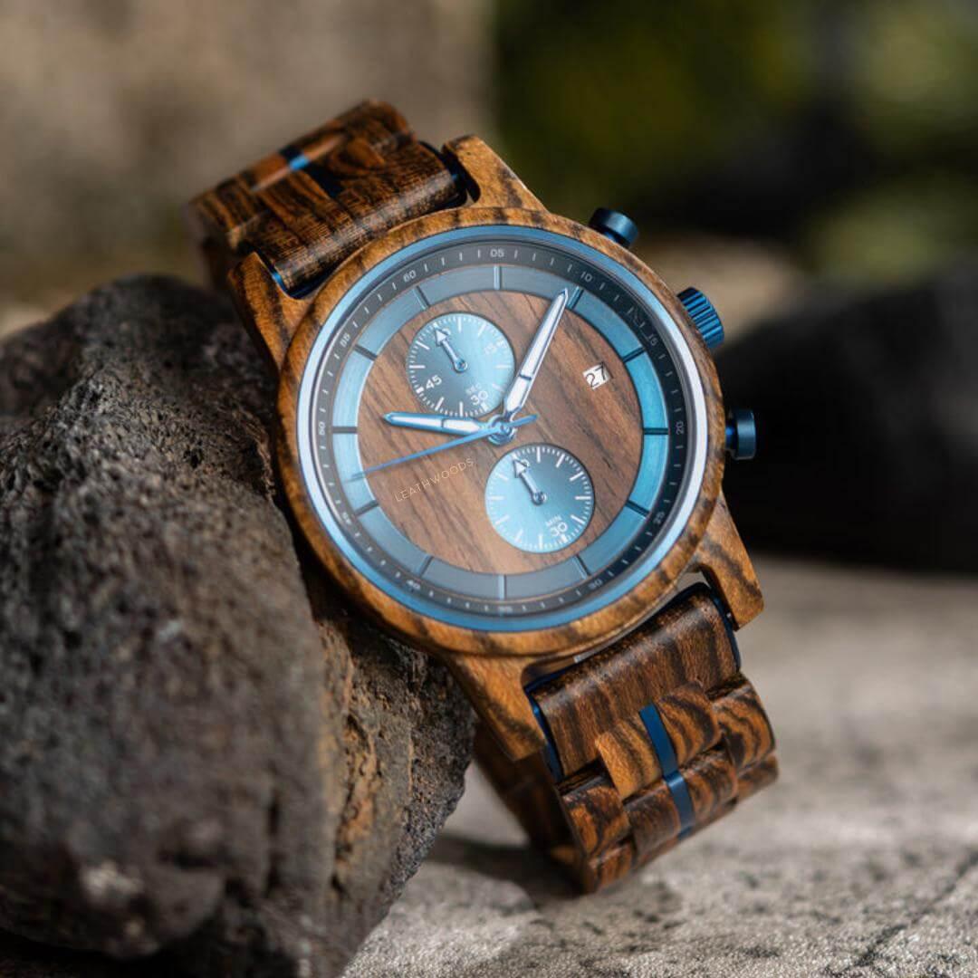 Leathwoods Morpho wooden watch with blue dials and wood grain strap on a rock