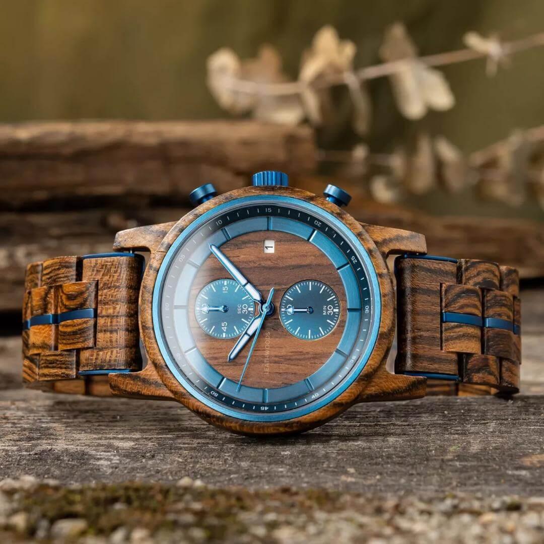 Men's wooden wristwatch with blue accents on a rustic wood background