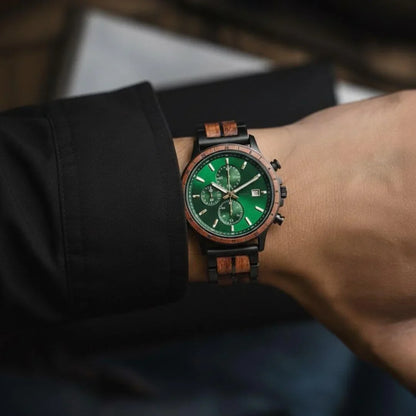Men's wooden wristwatch with green dial and walnut wood accents on a wrist
